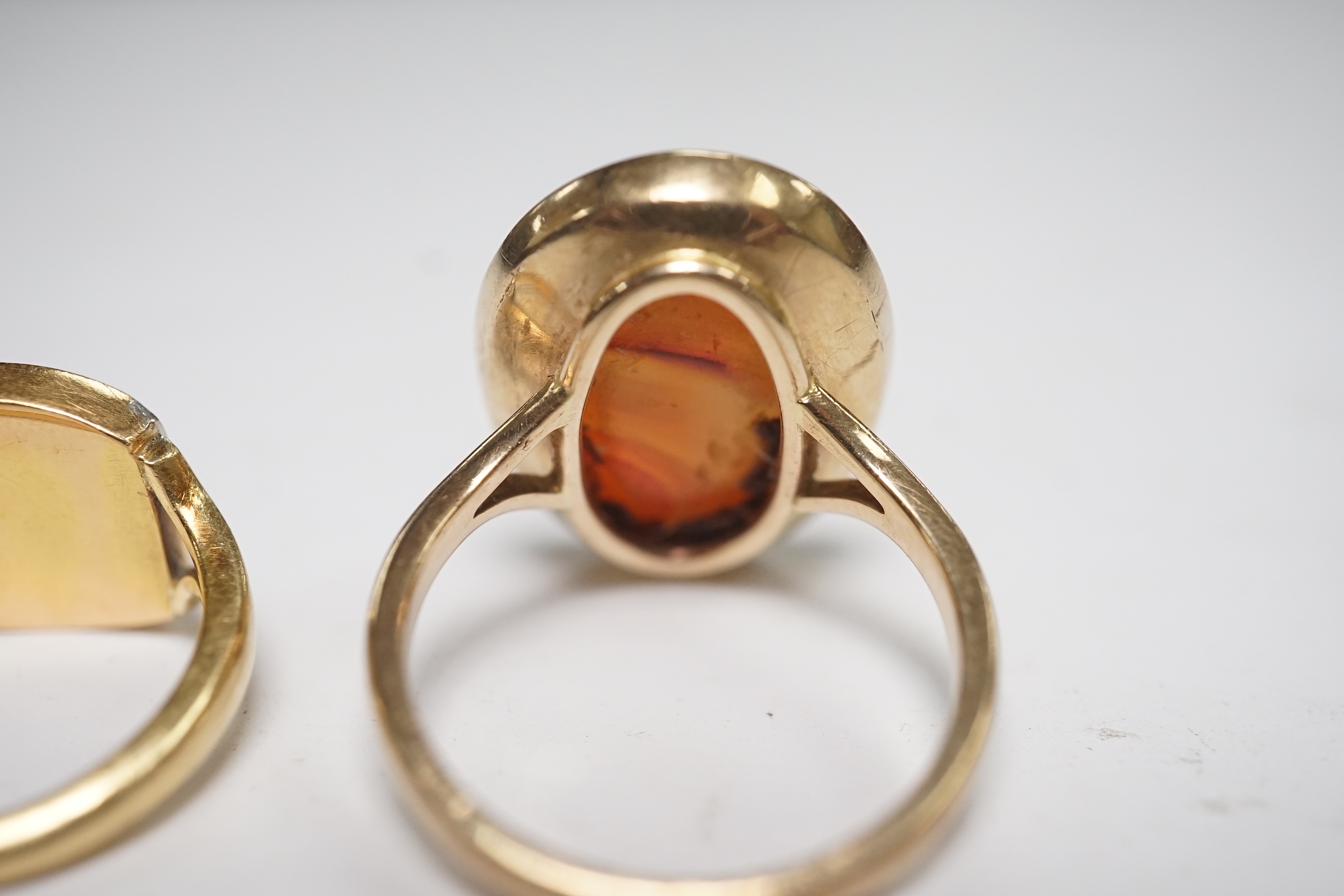 A yellow metal and intaglio agate set oval ring, size P, together with a modern 18ct gold signet ring, engraved with a bird, gross weight 12.3 grams. Condition - poor to fair